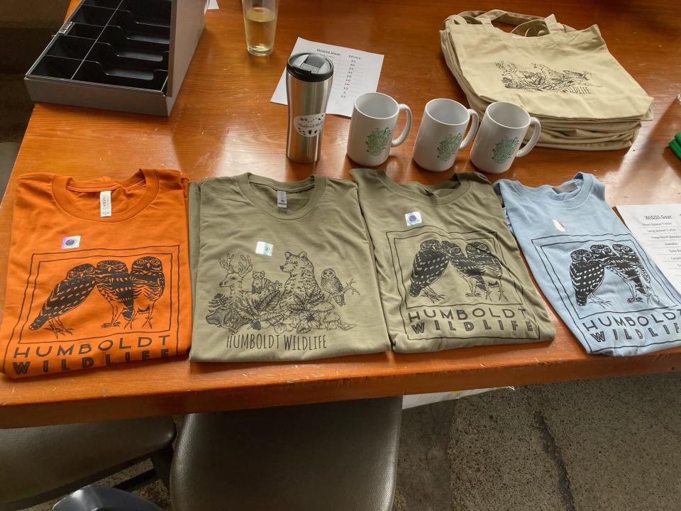WiGSS tshirts with owl logo on a table