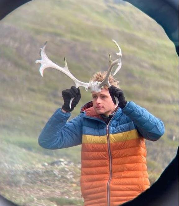 Evan holding up antlers to his head